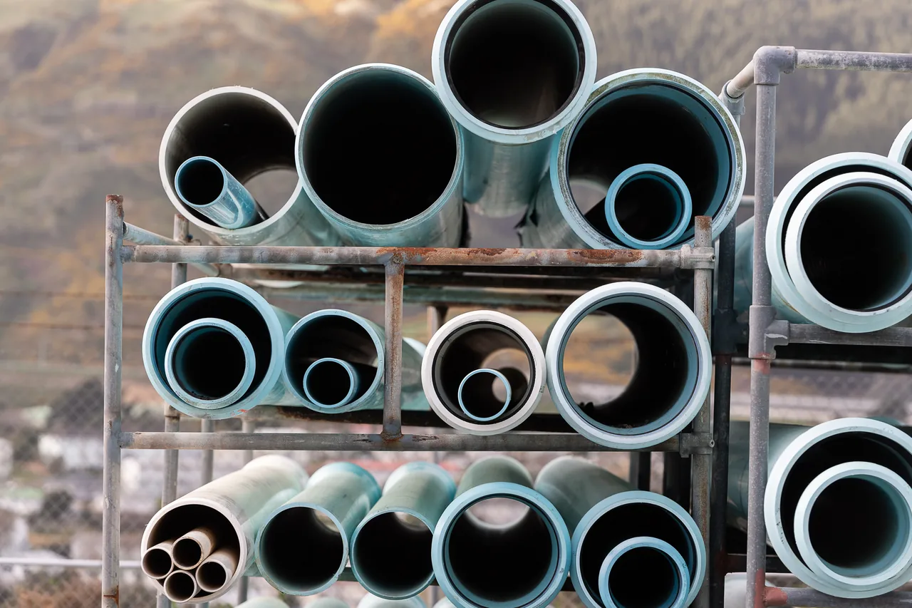 Wellington Water pipe stock in assorted diameters, stacked on a steel rack ellington Water pipe stock in assorted diameters, stacked on a steel rack